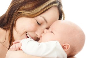 Mother smile to her child, isolated over white
